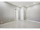 Neutral bedroom with tile floors, two doors, and natural light at 1800 N 156Th Dr, Goodyear, AZ 85395