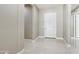 Bright entryway featuring neutral walls, white trim and door, and glossy tile flooring at 1800 N 156Th Dr, Goodyear, AZ 85395