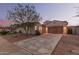 Inviting single-story home featuring desert landscaping and a two-car garage with a long concrete driveway at 1800 N 156Th Dr, Goodyear, AZ 85395