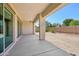 A large covered patio area overlooks the backyard with block wall fencing at 1800 N 156Th Dr, Goodyear, AZ 85395