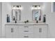 Modern bathroom features dual sinks, quartz counters, and contemporary lighting at 18402 N 94Th Dr, Sun City, AZ 85373