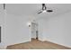 Modern bedroom with ceiling fan and door leading to ensuite bathroom at 18402 N 94Th Dr, Sun City, AZ 85373