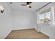 Bright bedroom with large window and ceiling fan at 18402 N 94Th Dr, Sun City, AZ 85373