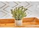 Close up of a decorative house plant in a stone-like pot atop a wood tray at 18402 N 94Th Dr, Sun City, AZ 85373