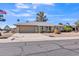 Inviting single-story home with neutral paint, a low maintenance front yard, and spacious driveway at 18402 N 94Th Dr, Sun City, AZ 85373