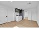 Bright laundry room with front load washer, dryer, modern cabinetry and doorway to next room at 18402 N 94Th Dr, Sun City, AZ 85373