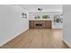 Bright living room with hardwood floors, linear fireplace, and natural light at 18402 N 94Th Dr, Sun City, AZ 85373