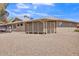 Rear view of home featuring desert landscaping, a covered patio, and neutral paint at 18402 N 94Th Dr, Sun City, AZ 85373