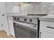 Stainless steel stove and oven with marble backsplash and countertops at 18402 N 94Th Dr, Sun City, AZ 85373