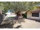 Backyard with mature trees and covered patio, perfect for outdoor enjoyment at 18660 N 71St Ln, Glendale, AZ 85308