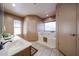 Bathroom featuring a soaking tub, window, and vanity with a white countertop at 18660 N 71St Ln, Glendale, AZ 85308