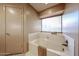 Bathroom featuring a soaking tub, window, and neutral colored walls at 18660 N 71St Ln, Glendale, AZ 85308