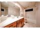 Bathroom features a vanity with drawers, mirror and shower-tub combo at 18660 N 71St Ln, Glendale, AZ 85308