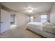 Bright bedroom featuring a ceiling fan, plush carpet and windows with wooden blinds at 18660 N 71St Ln, Glendale, AZ 85308