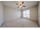 Bedroom featuring a ceiling fan and a window at 18660 N 71St Ln, Glendale, AZ 85308