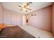 Bedroom featuring two closets, a ceiling fan, and a shelf at 18660 N 71St Ln, Glendale, AZ 85308