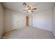 Neutral bedroom features ceiling fan, carpet, and two doors at 18660 N 71St Ln, Glendale, AZ 85308