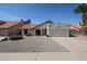 Charming single-Gathering home featuring desert landscaping, an attached two-car garage, and a red tile roof at 18660 N 71St Ln, Glendale, AZ 85308