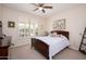 Bedroom with a large window, ceiling fan, and dark wood furniture at 20047 N Shadow Mountain Dr, Surprise, AZ 85374