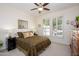 Bedroom with large windows, ceiling fan, and neutral decor at 20047 N Shadow Mountain Dr, Surprise, AZ 85374