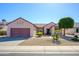 Inviting single-story home features a landscaped front yard with desert landscaping and a two-car garage at 20047 N Shadow Mountain Dr, Surprise, AZ 85374