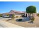 Charming single-story home showcases neat desert landscaping and a neutral color scheme at 20047 N Shadow Mountain Dr, Surprise, AZ 85374