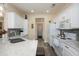 Bright eat-in kitchen featuring white cabinetry, marble countertops, and stainless steel appliances at 20047 N Shadow Mountain Dr, Surprise, AZ 85374