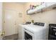 Laundry room featuring large capacity washer and dryer with shelving at 20047 N Shadow Mountain Dr, Surprise, AZ 85374