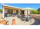 Enjoy outdoor relaxation on the covered patio with comfortable seating and an umbrella at 20047 N Shadow Mountain Dr, Surprise, AZ 85374