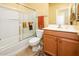 Bright bathroom featuring a shower-tub combination with sliding glass doors and tile flooring at 20449 N Lemon Drop Dr, Maricopa, AZ 85138