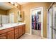 Bright bathroom with double sinks, ample cabinetry, and walk-in closet at 20449 N Lemon Drop Dr, Maricopa, AZ 85138