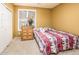 Well-lit bedroom featuring a ceiling fan, closet, and a three-drawer dresser at 20449 N Lemon Drop Dr, Maricopa, AZ 85138