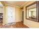 Welcoming entryway with neutral paint, wood floors, and large mirror for a spacious feel at 20449 N Lemon Drop Dr, Maricopa, AZ 85138