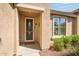 Inviting front entrance with security door, desert landscaping, and covered entry way at 20449 N Lemon Drop Dr, Maricopa, AZ 85138