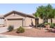 Charming single-story home featuring a two-car garage, desert landscaping, and a cozy front porch with bench seating at 20449 N Lemon Drop Dr, Maricopa, AZ 85138