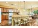 Bright kitchen with wooden cabinetry, an island, and adjacent dining area at 20449 N Lemon Drop Dr, Maricopa, AZ 85138