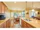 Spacious kitchen featuring wood floors, a granite topped center island, and an adjacent dining area at 20449 N Lemon Drop Dr, Maricopa, AZ 85138