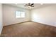 Spacious carpeted bedroom offering natural light from a window at 2101 S Meridian Rd # 42, Apache Junction, AZ 85120