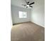 Bright bedroom with neutral carpet, a ceiling fan, and a window for natural light at 2101 S Meridian Rd # 42, Apache Junction, AZ 85120