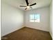 Bright bedroom featuring neutral carpet, white walls, a ceiling fan and a window at 2101 S Meridian Rd # 42, Apache Junction, AZ 85120