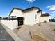 A nice house with desert landscaping, walled side yard, and a brown tile roof at 2101 S Meridian Rd # 42, Apache Junction, AZ 85120