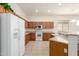 Bright kitchen with a white refrigerator and appliances, plus lots of cabinets for storage at 26065 N 68Th Ln, Peoria, AZ 85383