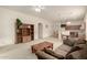 Inviting living room featuring neutral colors, a built-in bookcase, and views into the kitchen at 26065 N 68Th Ln, Peoria, AZ 85383