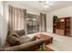 Relaxing living room with a ceiling fan and sliding glass door to the backyard at 26065 N 68Th Ln, Peoria, AZ 85383