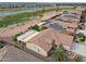 Gorgeous aerial view of a home near a golf course with lake and mountain views at 2634 N 164Th Ave, Goodyear, AZ 85395