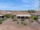 Aerial view of a well-maintained backyard with desert landscaping and a covered patio at 2634 N 164Th Ave, Goodyear, AZ 85395