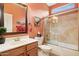 Bathroom features an enclosed shower, vanity with sink, and earthy toned walls at 2634 N 164Th Ave, Goodyear, AZ 85395