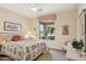 Bedroom features a ceiling fan and a window with a view of the backyard patio at 2634 N 164Th Ave, Goodyear, AZ 85395