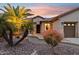 Charming home exterior with lush landscaping, a welcoming entrance, and a well-maintained facade at twilight at 2634 N 164Th Ave, Goodyear, AZ 85395