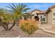 Beautiful home with mature palm trees, decorative rock landscaping, and a charming exterior at 2634 N 164Th Ave, Goodyear, AZ 85395